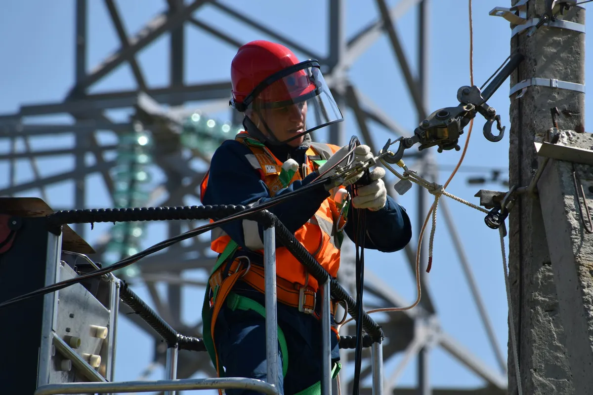 Electrical worker performing urgent repair work at height — illustrative stock photo, not an actual Pahrump job site