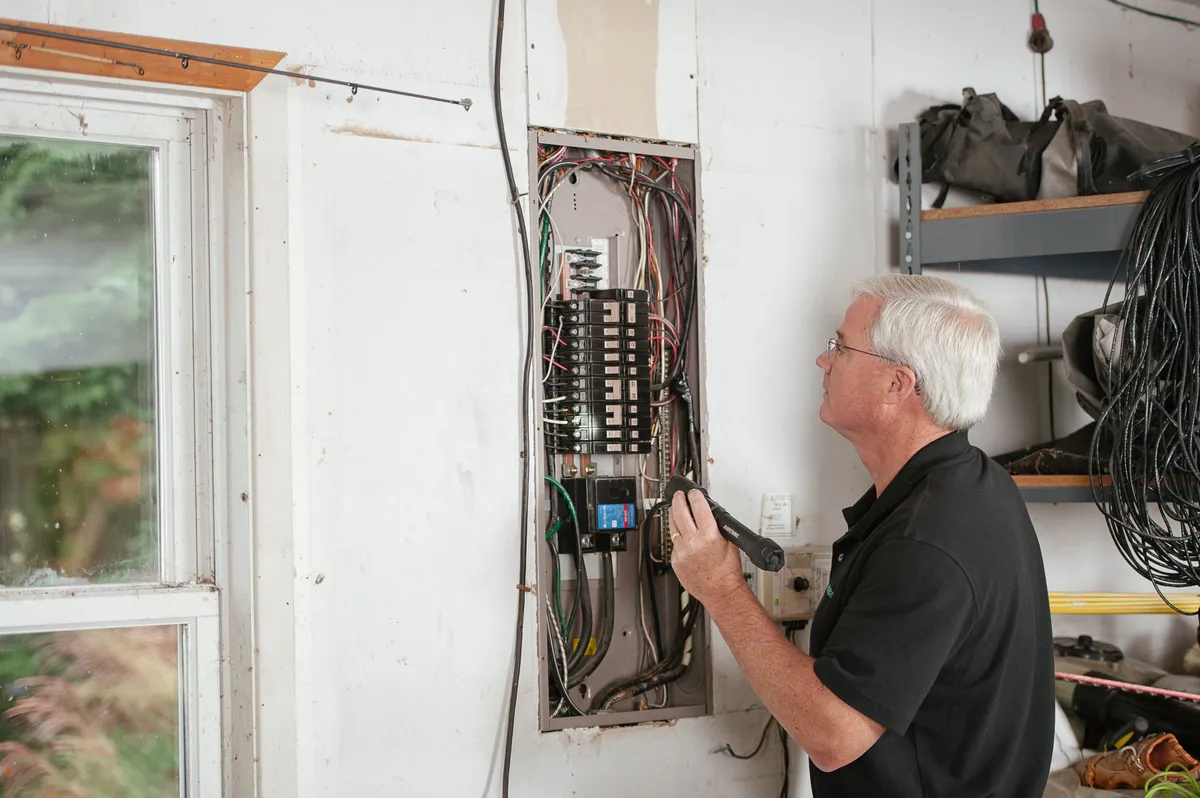 Electrician inspecting a residential circuit breaker panel — illustrative stock photo, not an actual Pahrump job site