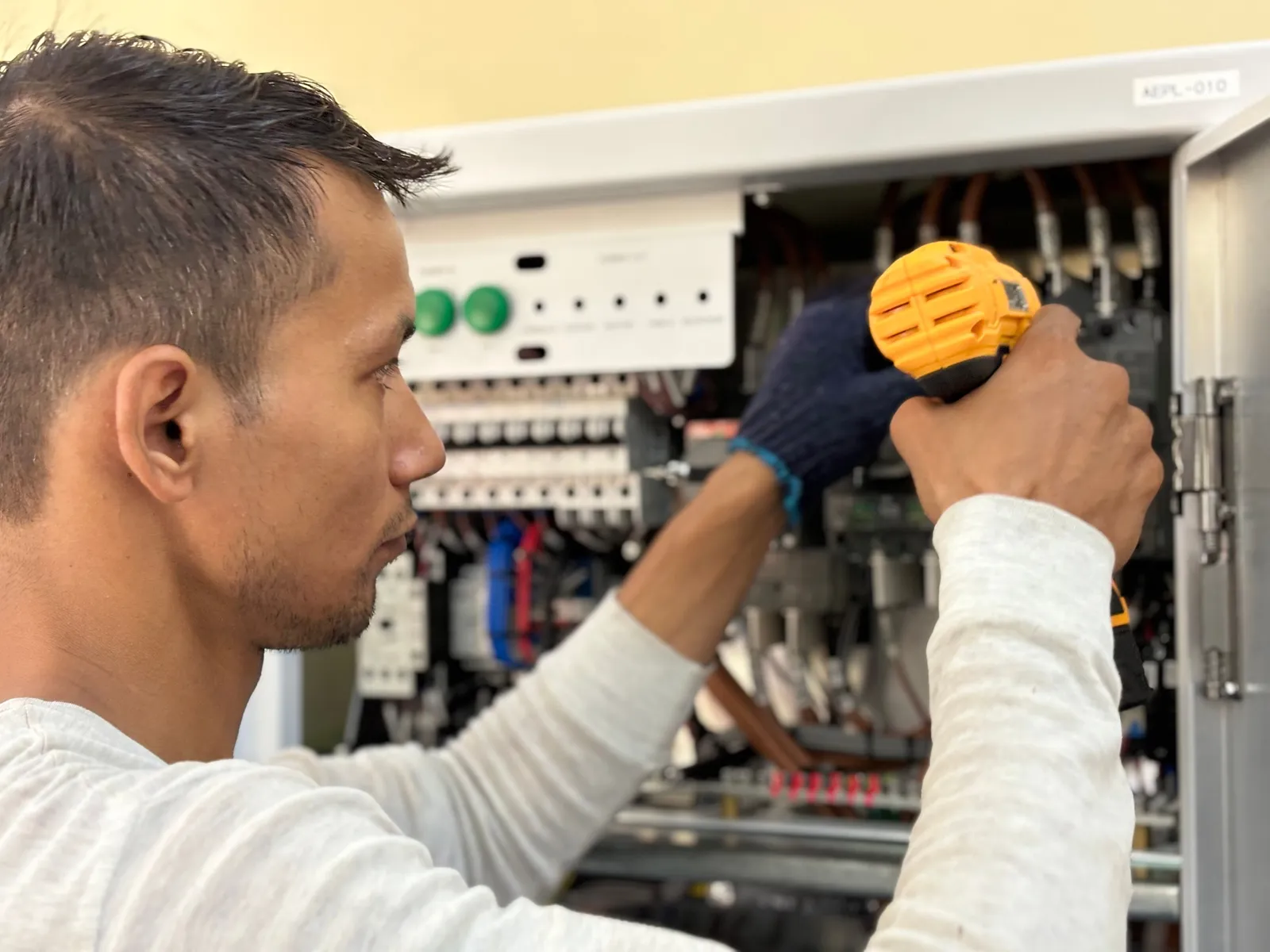 Electrician working inside an open circuit breaker panel — illustrative stock photo, not an actual Pahrump job site